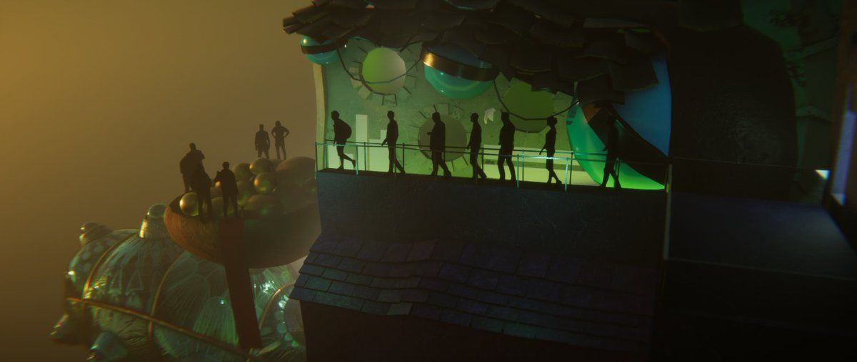 Silhouetted people looking over a glowing green miniature landscape in a dark gallery